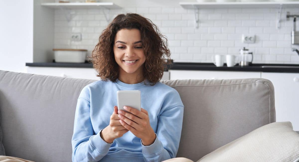 woman looking at her phone for her period tracker