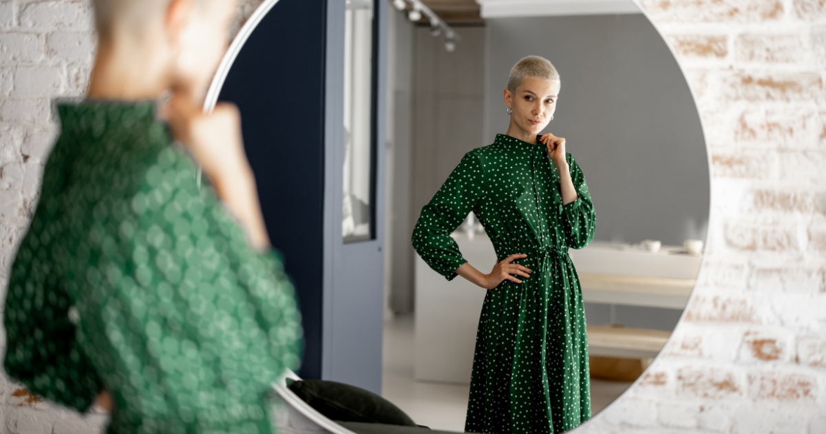 a woman looking at herself in the mirror